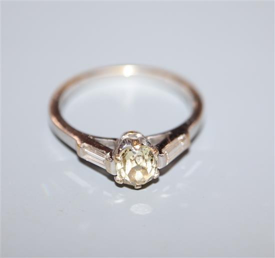 A modern 18ct white gold and fancy yellow single stone diamond ring, with baguette cut diamond set shoulders, size Q.